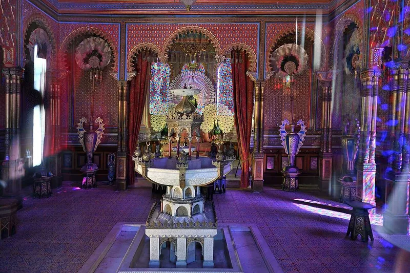 The interior of the Moorish Kiosk, its peacock throne under a painted and mirrored ceiling