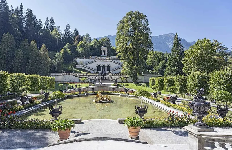 The terraced gardens climbing the hillside behind the palace in clipped stages